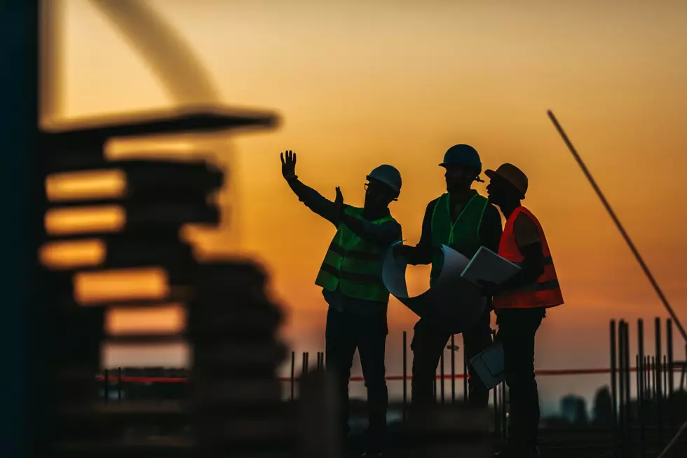 Construction workers work at twilight