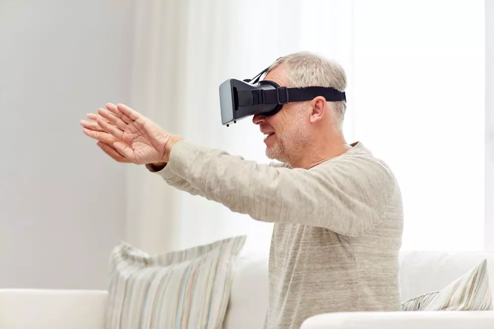 An older man wearing VR Goggles