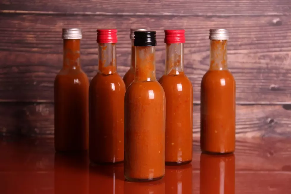 Five bottles of Hot Sauce on a table