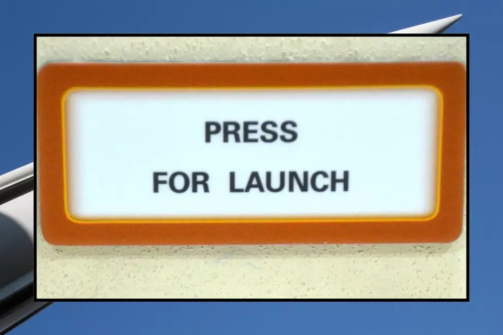 A sign that says "Press for Launch"