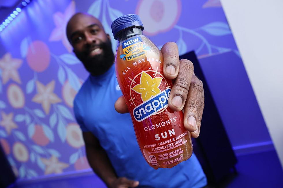 A man holds a bottle of snapple