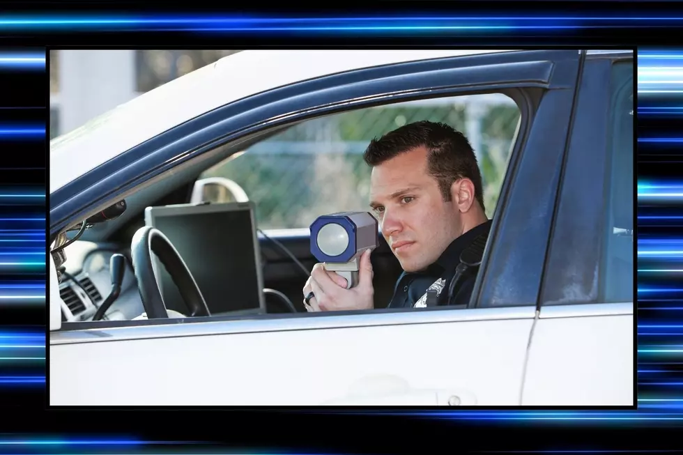 A police officer holds a radar gun