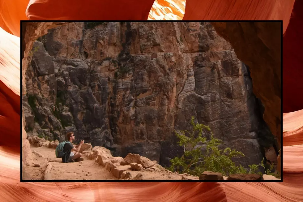 A man sits inside a cave at the Grand Canyon