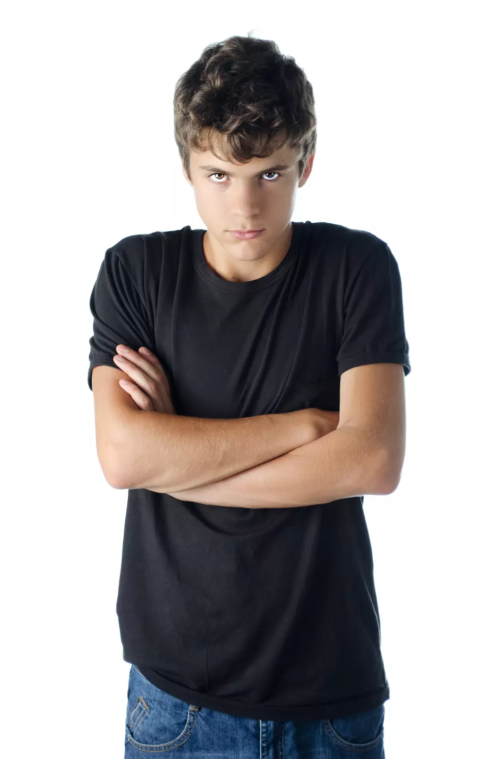 Teenage boy angry with arms crossed on his chest