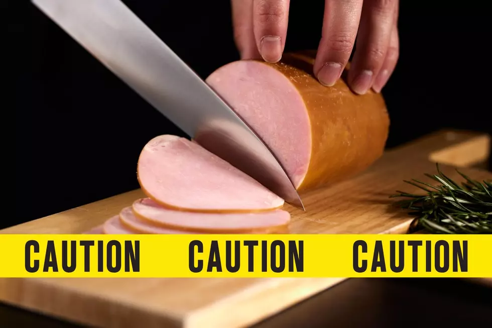 Knife cutting deli meat