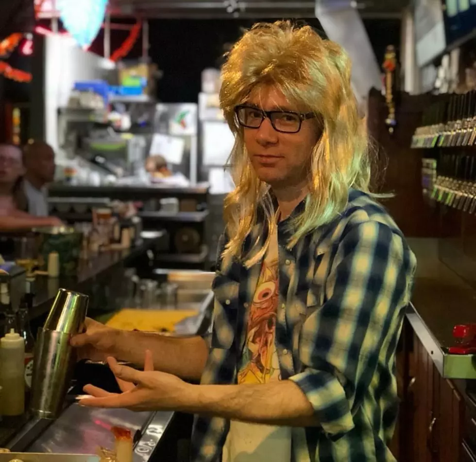 A bartender pokes fun at Garth from Wayne's World for a Halloween Party at Bill's Place in Downtown Yakima