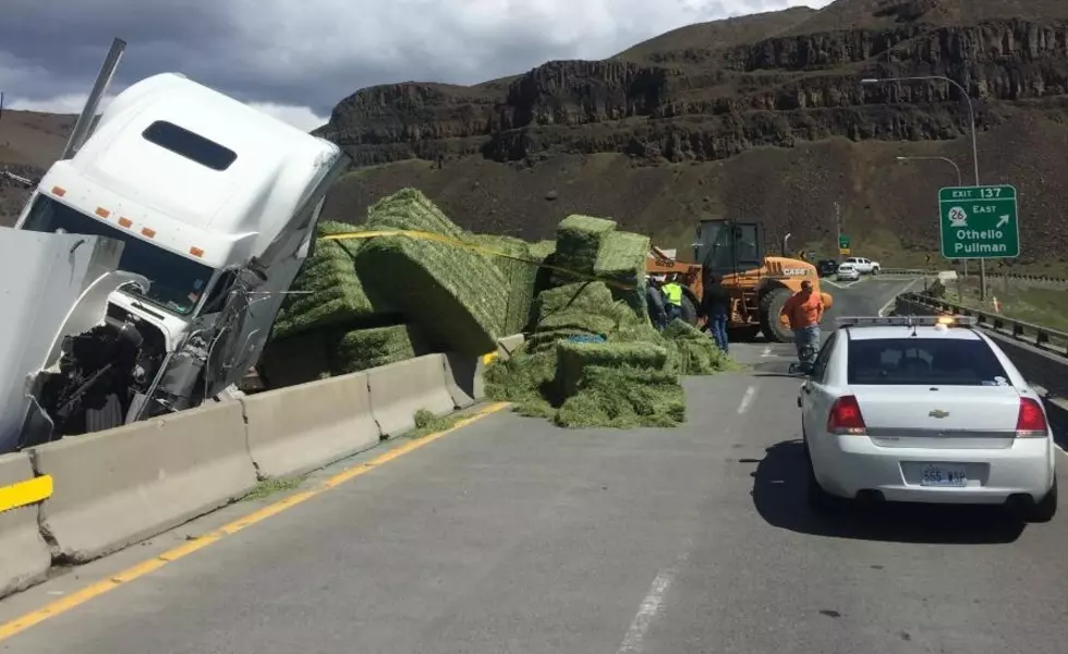 Full trailer of hay overturns, blocks I-90 for several hours