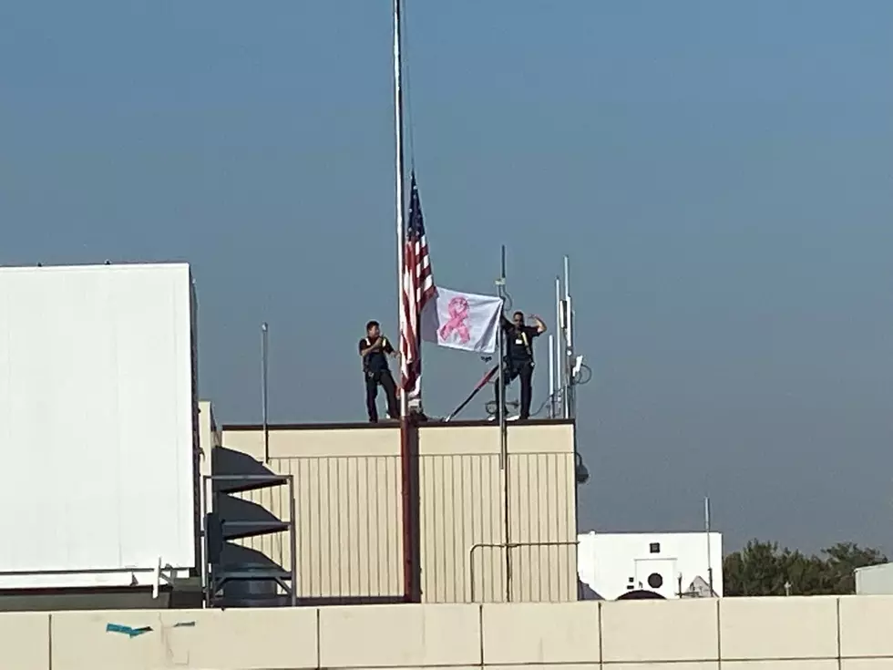 Kadlec Marks Breast Cancer Awareness Month with a Flag Raising