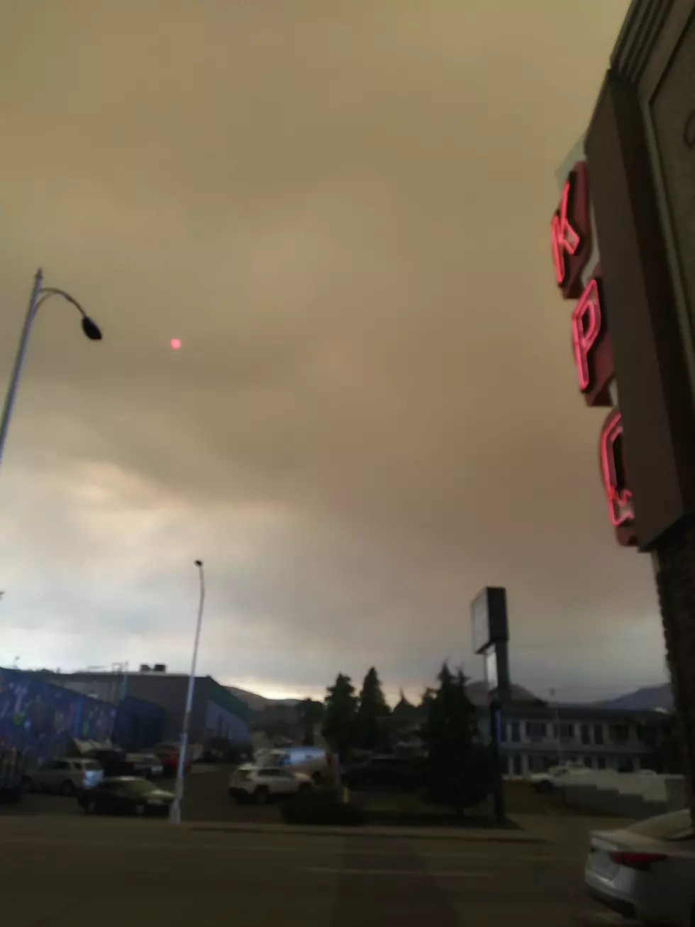 The sun appears as a glowing red cinder in the skies above the Wenatchee Valley outside the KPQ News studios on Thursday afternoon due to a thick drift of smoke from the Labor Mountain Fire (photo credit: Chris Hansen, Townsquare Media)