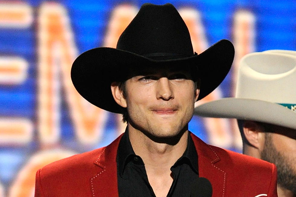 Ashton Kutcher Attends Kenny Chesney Show, Splashes Water on Paparazzi