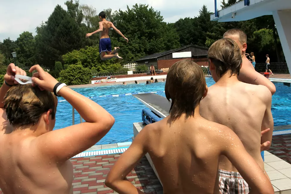 Boys Take Turns Diving Into The Pool