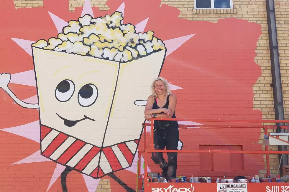 Jamestown artist Linda Roesch takes a break from putting the finishing touches on Mr. Popcorn / Robin Travers