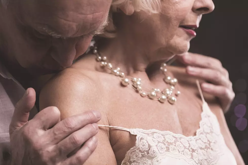Erotic picture - senior man kissing female arm