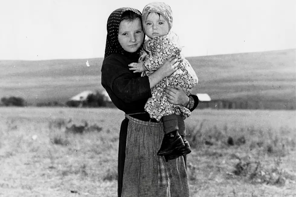 Hutterite girl holding her baby sister/ Galt Museum & Archives via Unsplash
