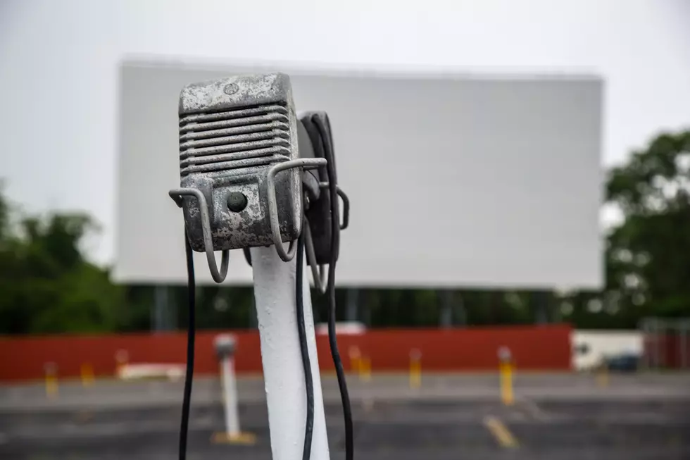 An vacant drive in movie theatre and its vintage speaker.