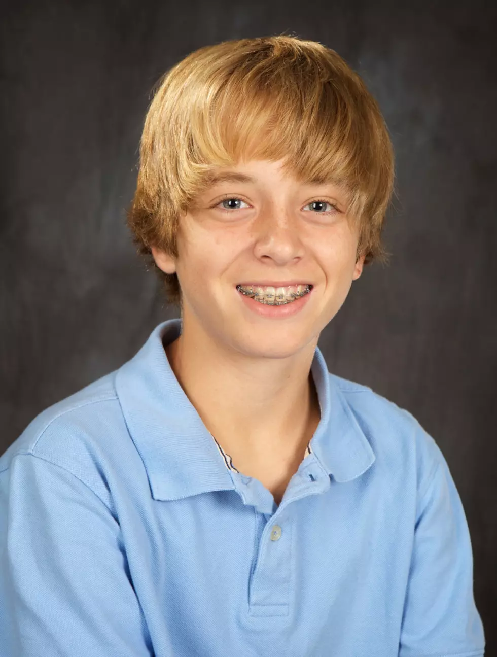 "A handsome blond hair, blue eyed teenage boy with braces"