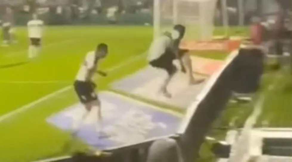 Soccer Player Jumps Barrier, Disappears