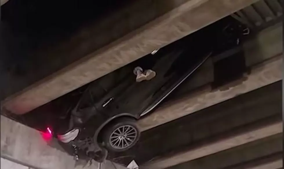 Car Confusingly Stuck In Between Overpass Beams