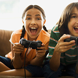 Girl and boy playing video game