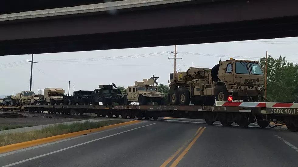 Dozens of Military Vehicles on a Train Through Bozeman