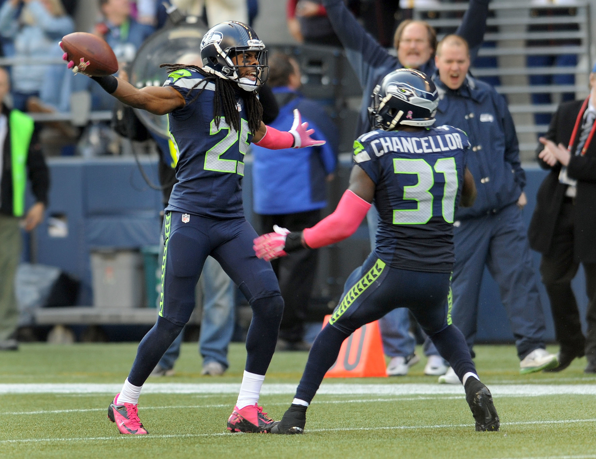 San Francisco 49ers cornerback Richard Sherman (25) is greeted by teammates  after Sherman inter …