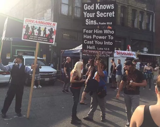 Jesus Guy Protesting Next To Dream Girls Guy In Seattle Before A Metal Concert &#8212; I Think Dream Girls Won!