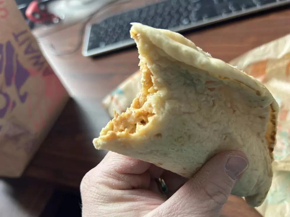 a flatbread chicken sandwich with a bite eaten in it.