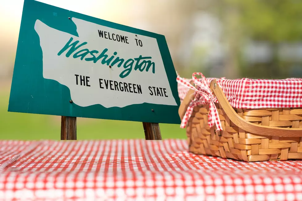picnic table with a basket on it. A welcome to washington sign in the background!