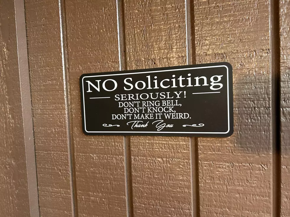 no solicting sign on a brown house.