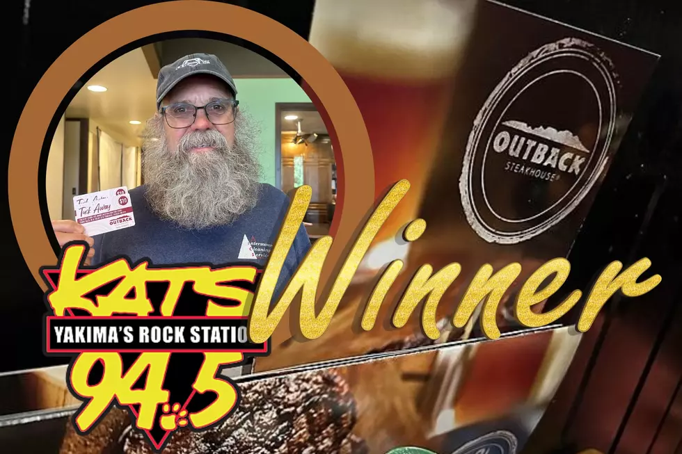 Man holding gift card, restaruant menu with a picture of a glass of beer on the menu
