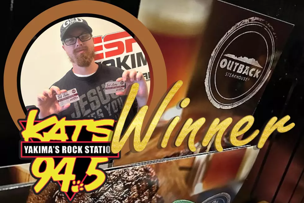 Man holding gift card, restaruant menu with a picture of a glass of beer on the menu