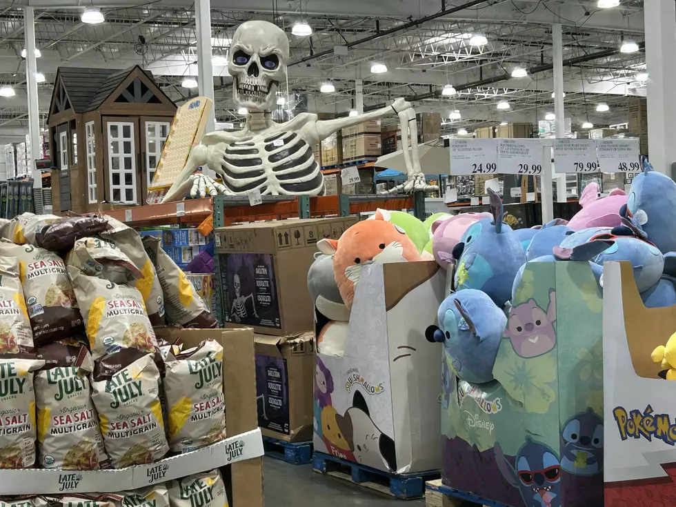 costco seasonal holiday rack at a store with a giant skeleton bust