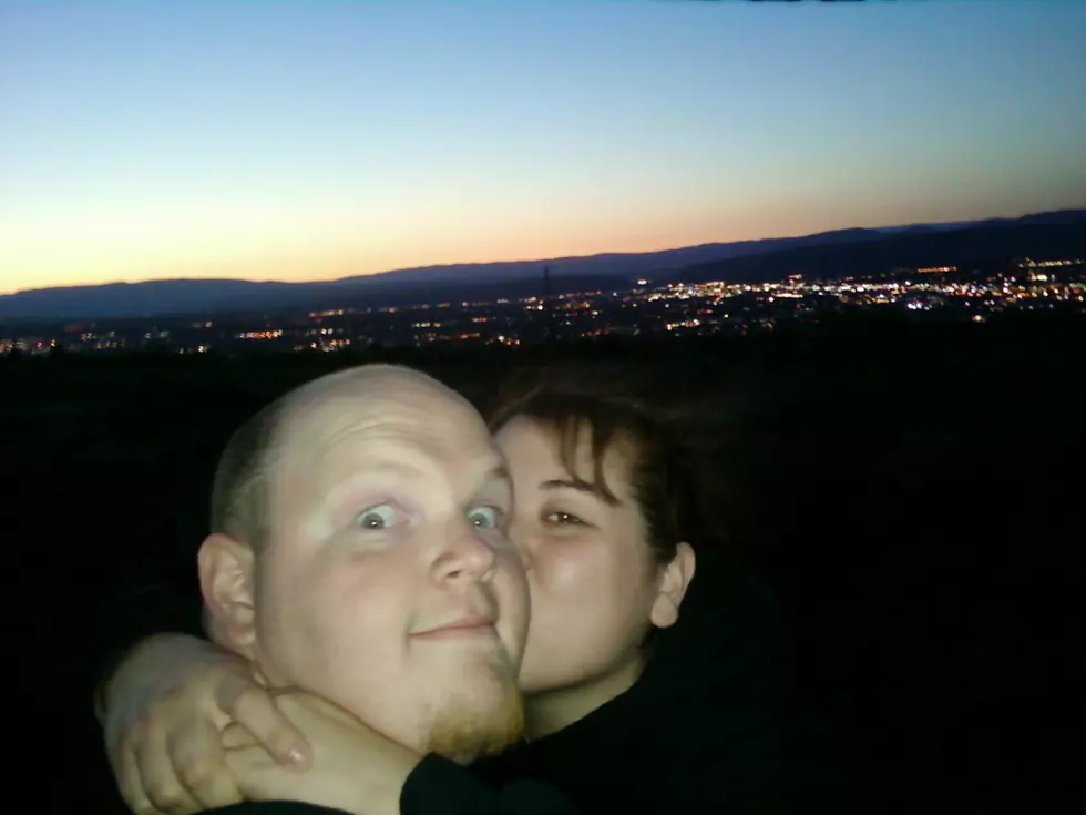 couple with city landscape behind them.