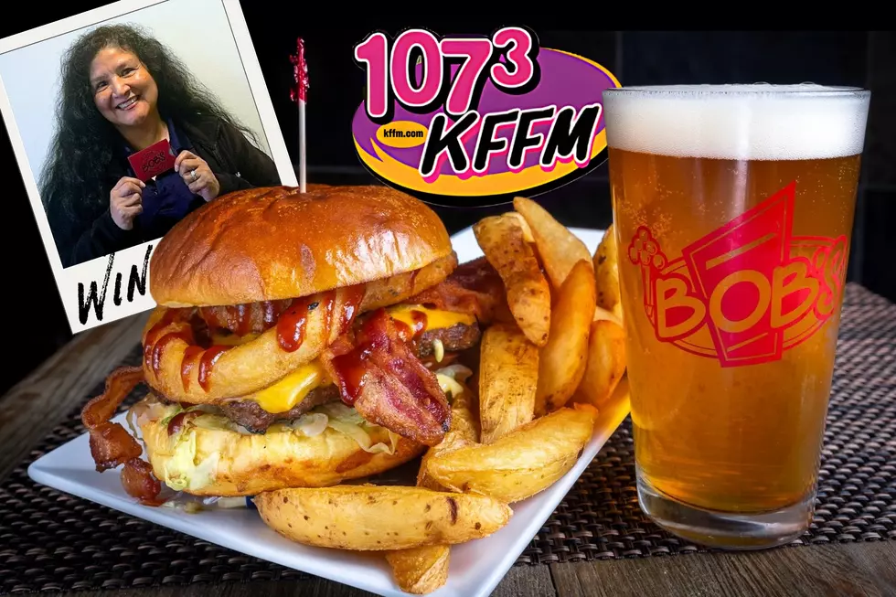 person holding gift card in a poleroid picture, Picture is next to a big hamburger and glass of beer with fries.