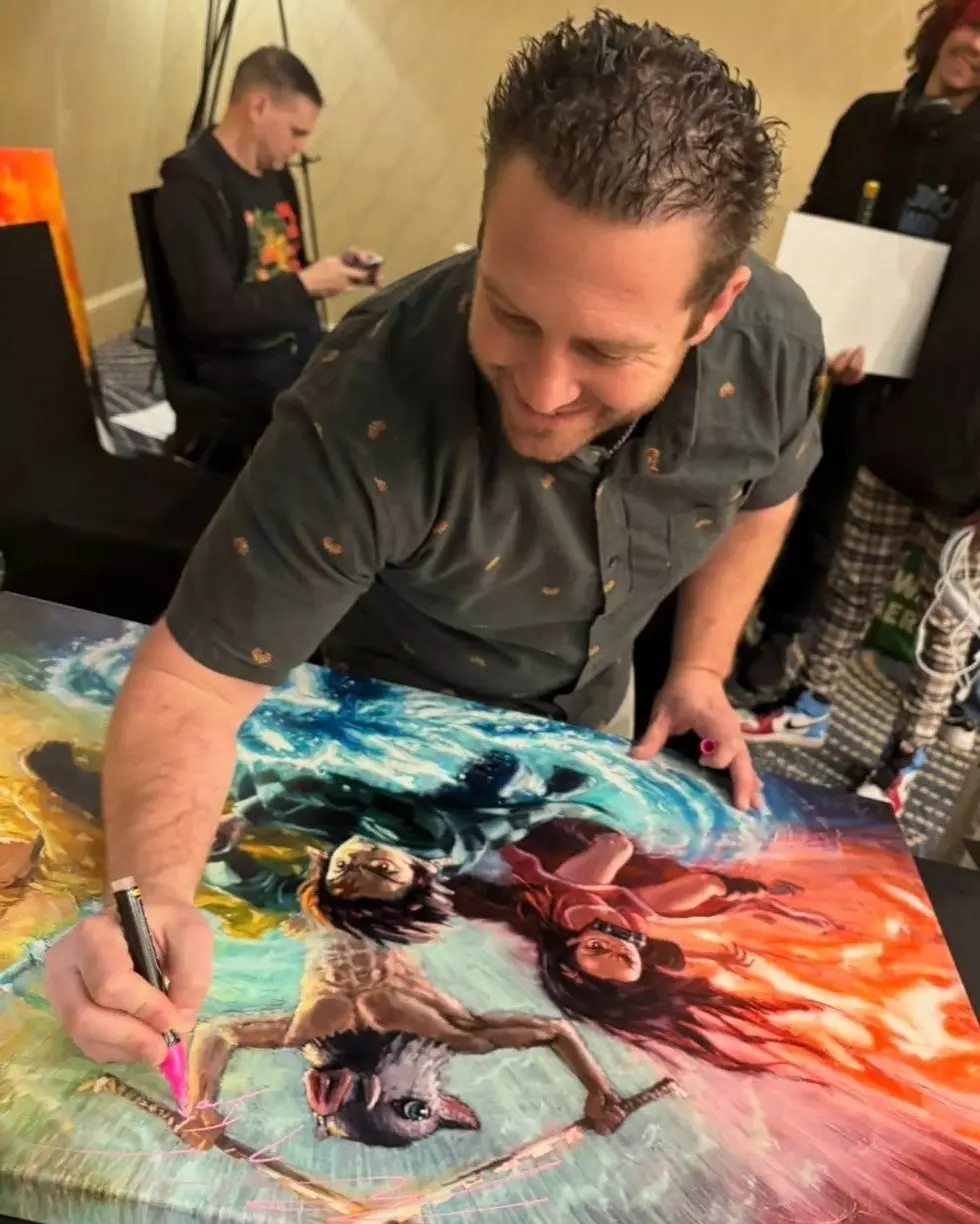 Celebrity giving autographs at Fan Fest Northwest
