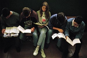 Young people studying Five young people study sat down in a bank of a corridor of the Santamarca Institute of High school. Madrid