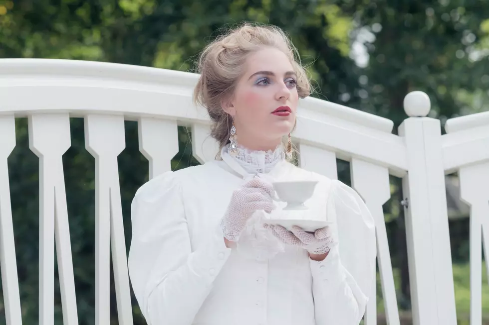 Victorian Woman drinking from a cup