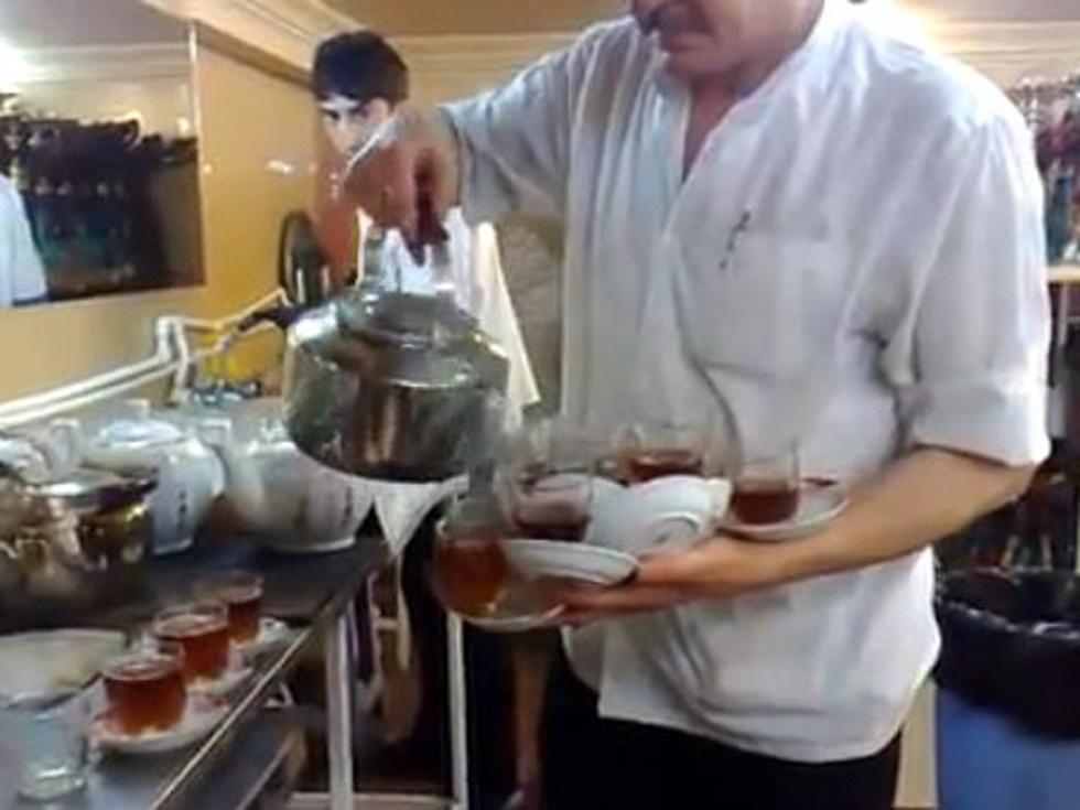 Amazing Waiter Carries 12 Full Tea Cup and Saucers in One Hand [VIDEO]