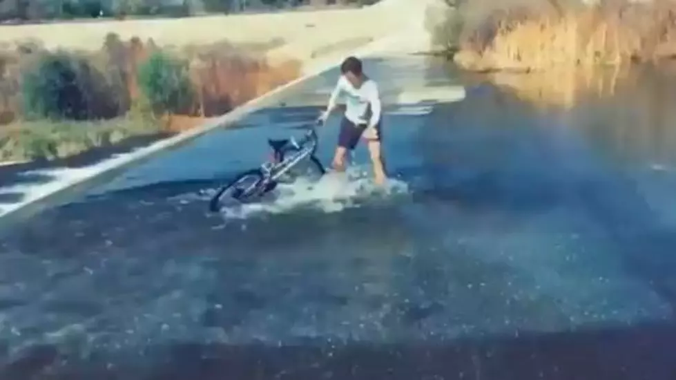 This Guy Trying To Ride His Bike Upstream Is All of Us In 2020