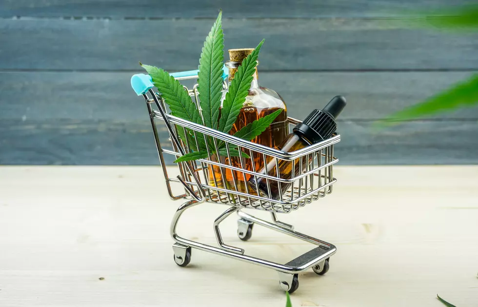 Supermarket trolley with marijuana leafs and medical cannabis oil cbd