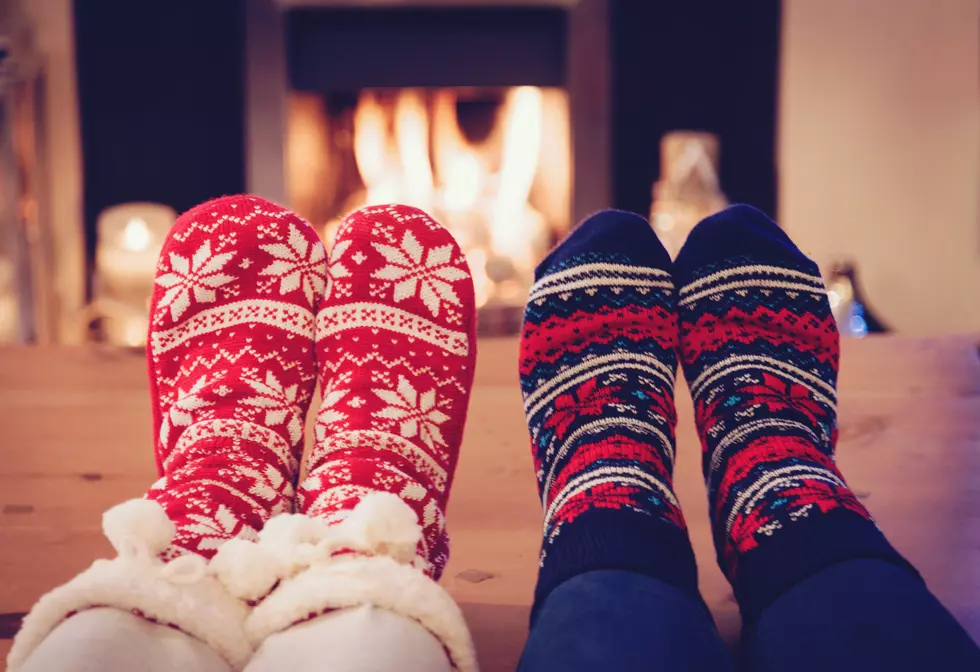Two pairs of Christmas socks against to fireplace.