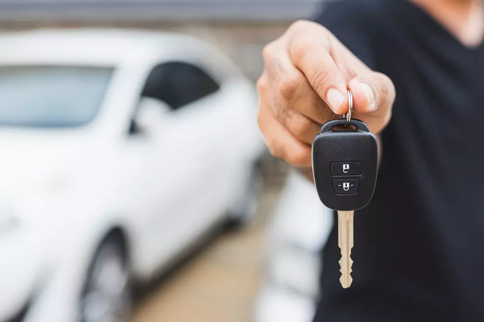Businessman giving a car key. Getting new car.