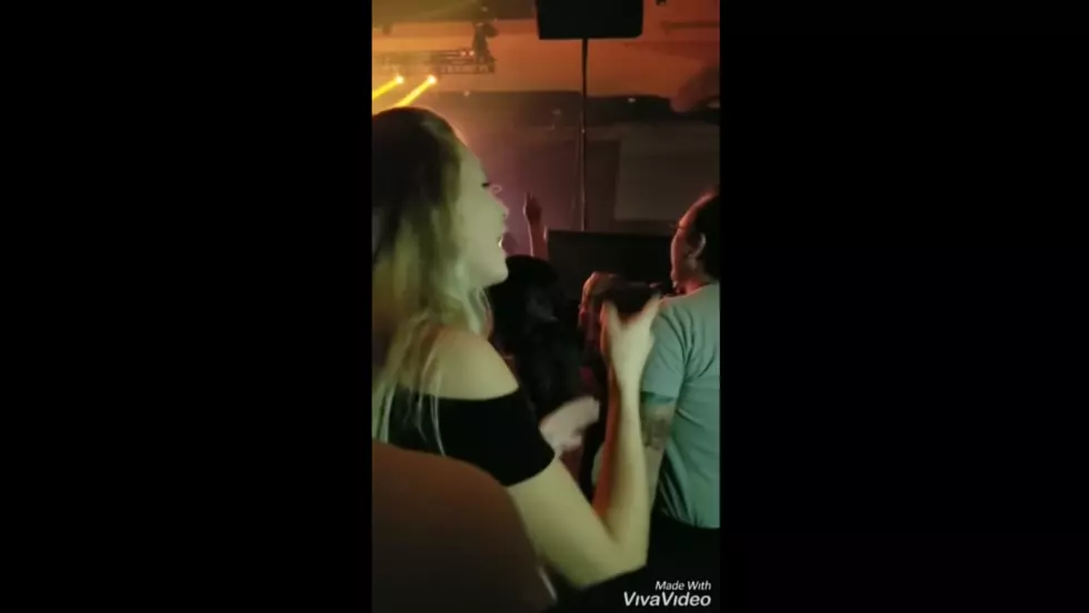 Daughter Signs for Father at Rock Concert