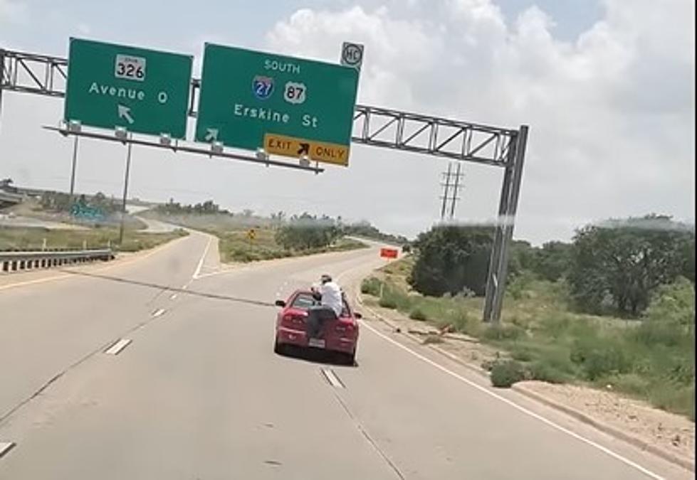 Video: Lubbock Idiot Rides on the Back of a Car Down Highway