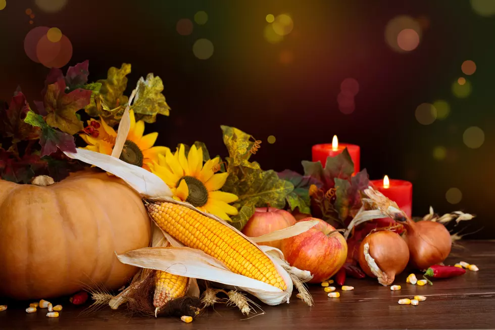 Autumnal fruits and vegetables against defocused holiday lights.
