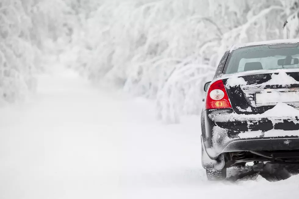 Black land vehicle standing on winter road