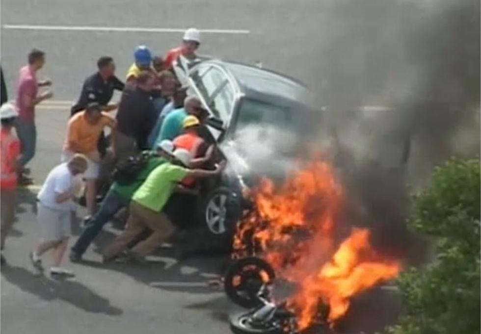 Bystanders Rescue Motorcyclist Trapped Under a Burning Car [VIDEO]