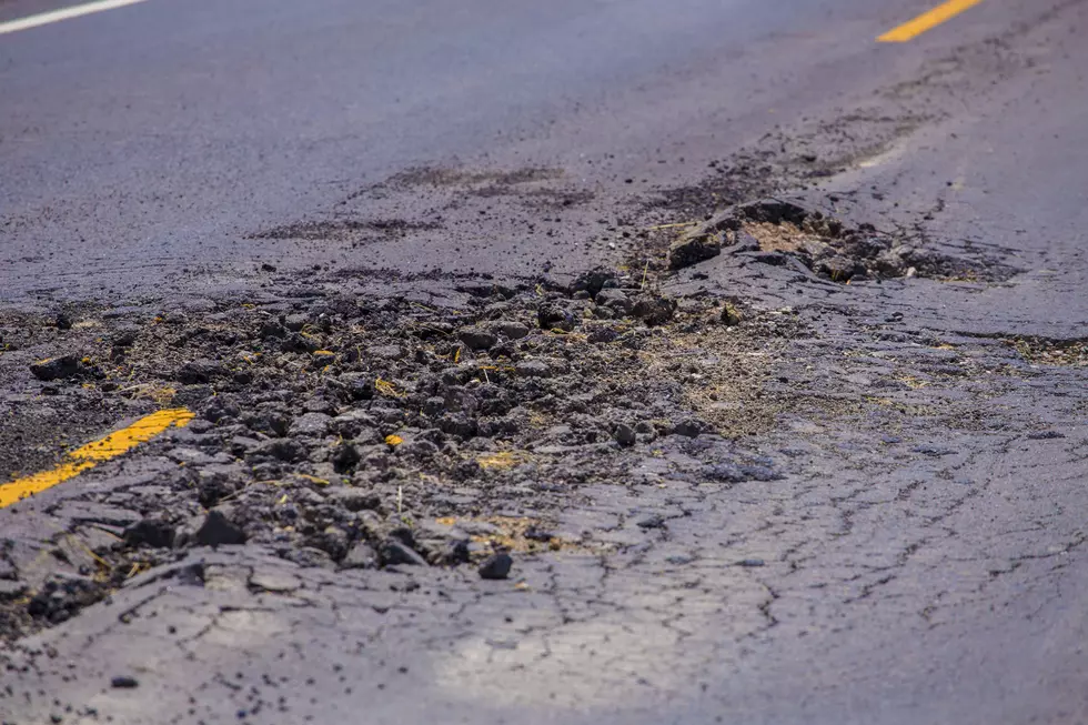 Damage asphalt concrete road. The hole is in center of the road.
