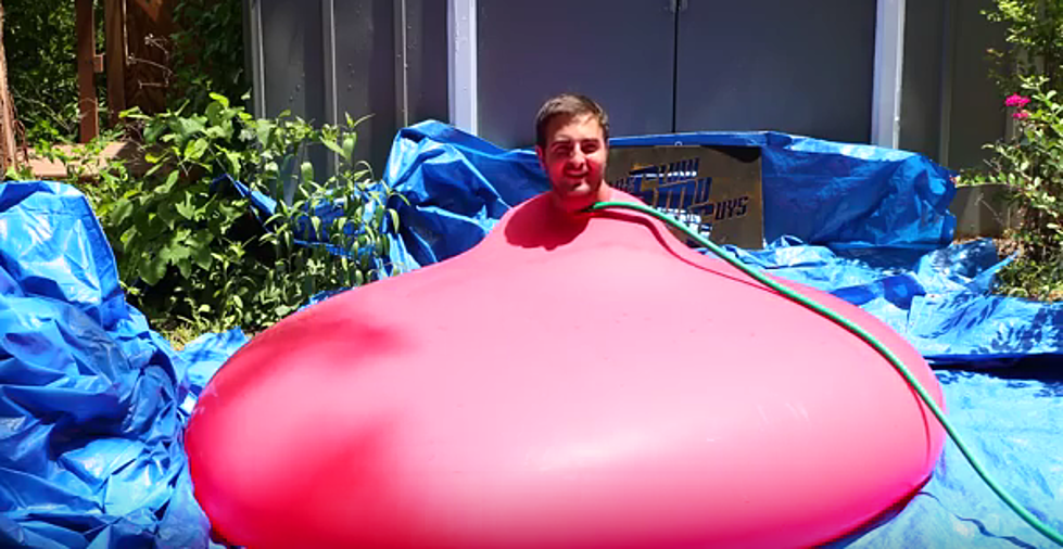 Watch This Guy Squeeze into Giant Water Balloon! [VIDEO]