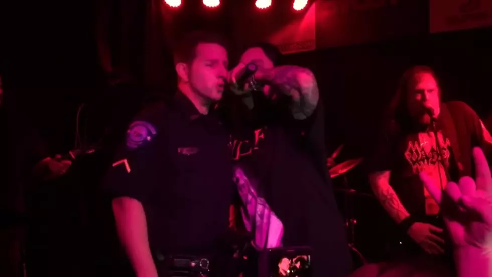 Cop Fired After Getting on Stage at Metal Show [VIDEO]